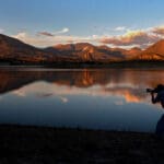Landscape image of Crawford Reservoir with the sunset reflecting in the water 