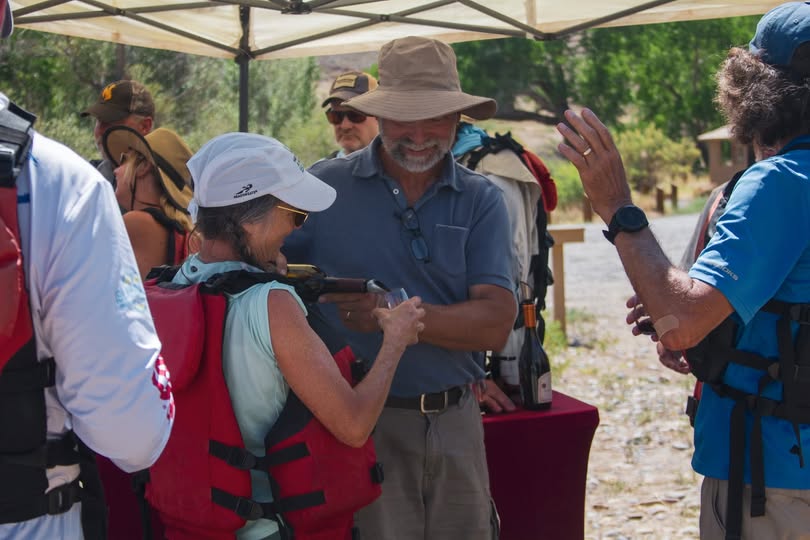 Promotional Image from Western Slope SUP of a group enjoying winder under a tent by the river